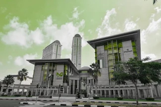 The modern, low-rise buildings and headquarters of Dubai Healthcare City (DHCC), with tall towers in the background and prominent green-tinted windows, set against a green-colored sky.