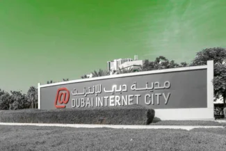 Dubai Internet City (DIC) sign in both English and Arabic, set against a bright green sky. This image represents the Dubai Internet City Free Zone.