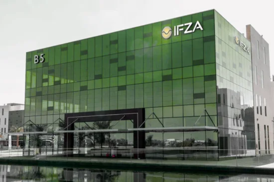 Consultant reviewing IFZA business setup documents and forms with a client.