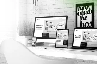 Multiple digital devices (desktop monitor, tablet, smartphone, laptop) on a desk, all displaying the same "Beautiful Websites" template.
