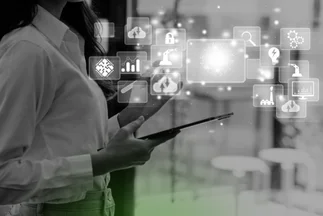 Woman holding a tablet with floating icons representing digital marketing data, cloud computing, and technology.