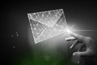 Hand touching a glowing, polygonal email or digital message icon, representing electronic communication or email marketing.