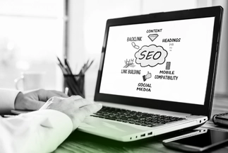 Laptop screen displaying a mind-map diagram of key SEO factors including backlink, content, mobile compatibility, and social media.