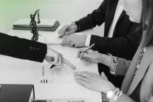 Business Structure Consultation where clients sign legal documents under expert guidance.