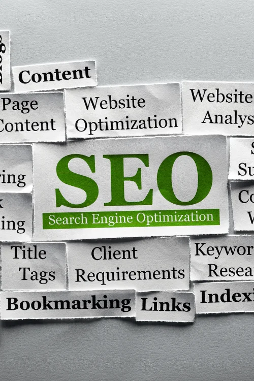 A collage of torn paper clippings with the words "SEO" in large green font, surrounded by related terms like "Content," "Links," and "Keyword Research."