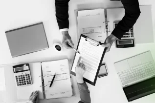 Legal consultants preparing and reviewing essential business incorporation documents and contracts.