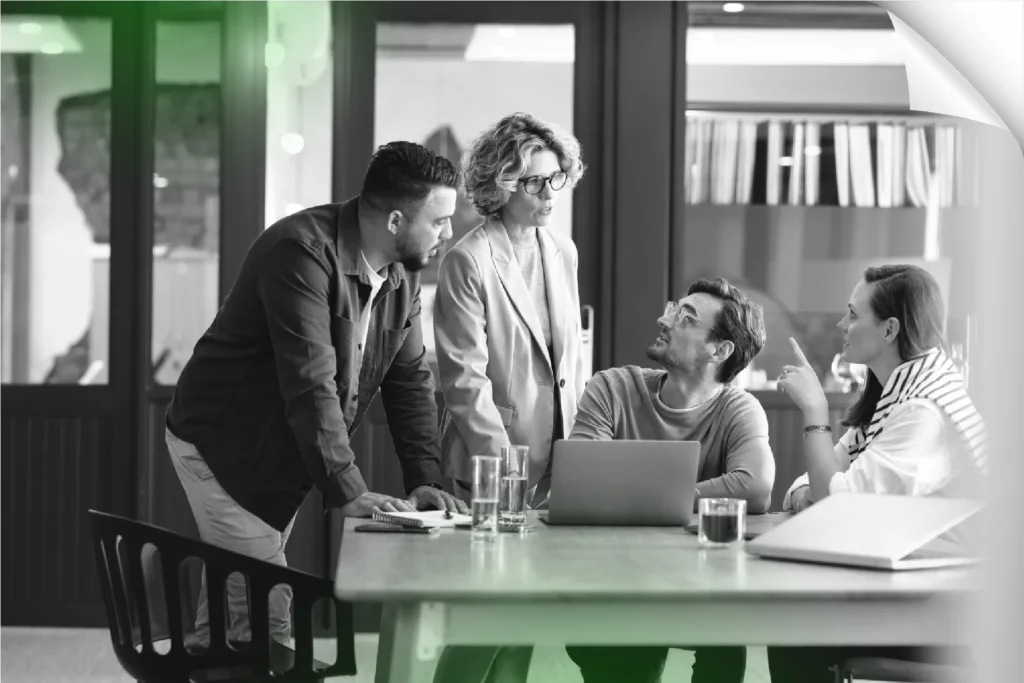 Collaborative team meeting discussing business strategy and financial planning in a modern office.