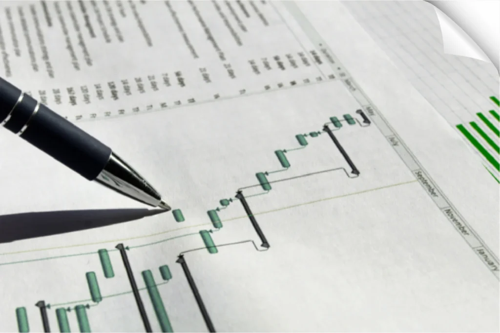 Financial consultant pointing at a Gantt chart during strategic planning for effective project management.