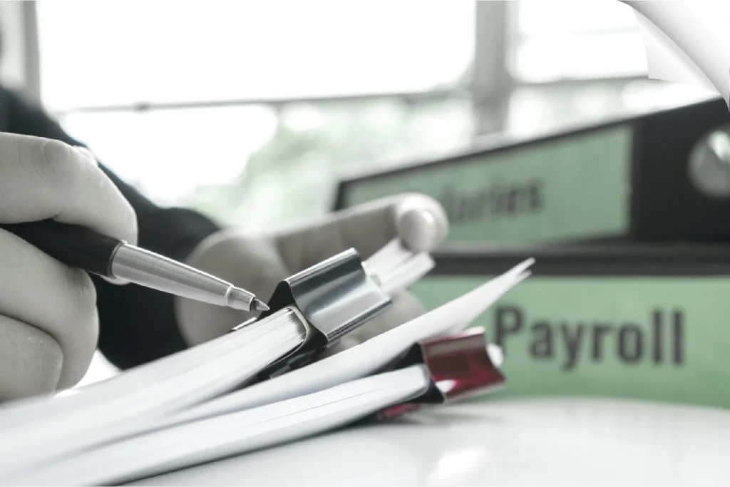 Close-up of a consultant managing payroll and reviewing salary documents for timely compliance.
